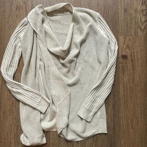 Beige All Saints sweater with a shoulder zipper and side opening.